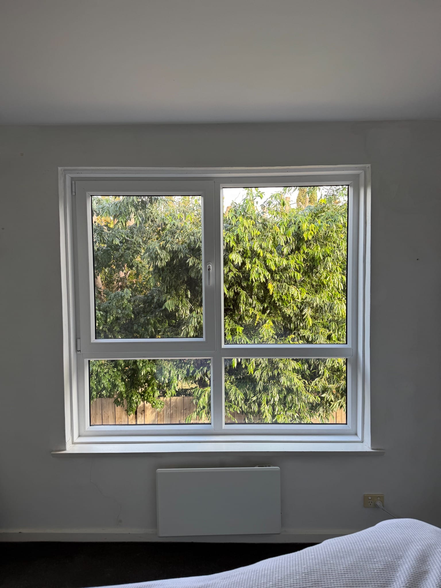 Windows Republic uPVC double glazed window installation in Melbourne bedroom with garden view — energy efficient soundproof window