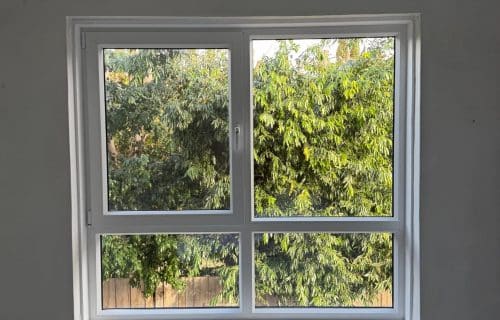 Windows Republic uPVC double glazed window installation in Melbourne bedroom with garden view — energy efficient soundproof window